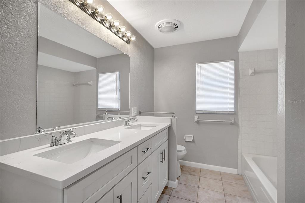 114 Barkfield Street Brandon, FL 33511 - Photo 42 of 59 a bathroom with a sink double vanity and a mirror