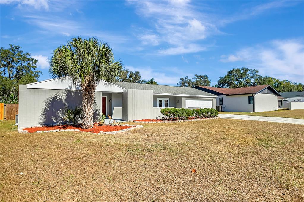 114 Barkfield Street Brandon, FL 33511 - Photo 58 of 59 a front view of a house with a yard and garage