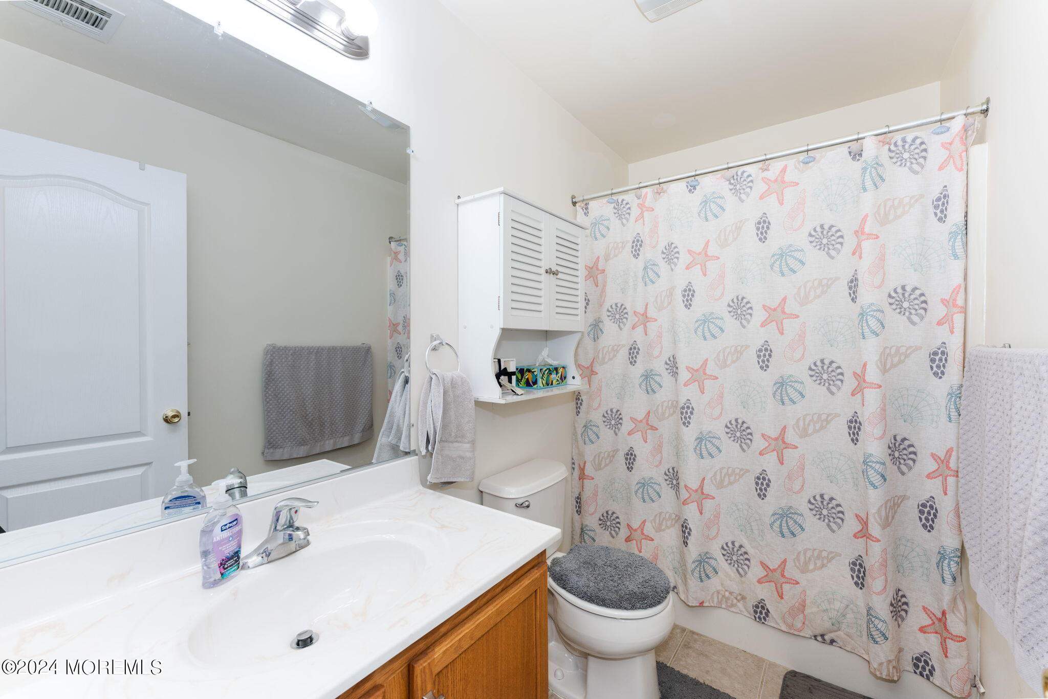 83 Gunning River Road Barnegat, NJ 08005 - Photo 16 of 24 a bathroom with a sink a toilet and shower curtain