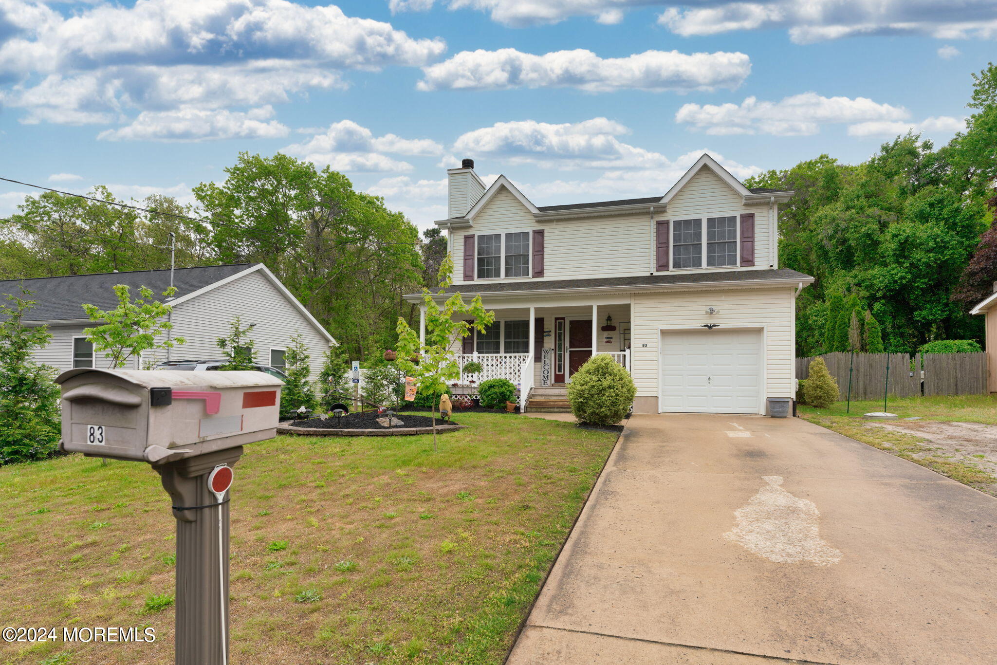 83 Gunning River Road Barnegat, NJ 08005 - Photo 3 of 24 a front view of a house with a yard and garage