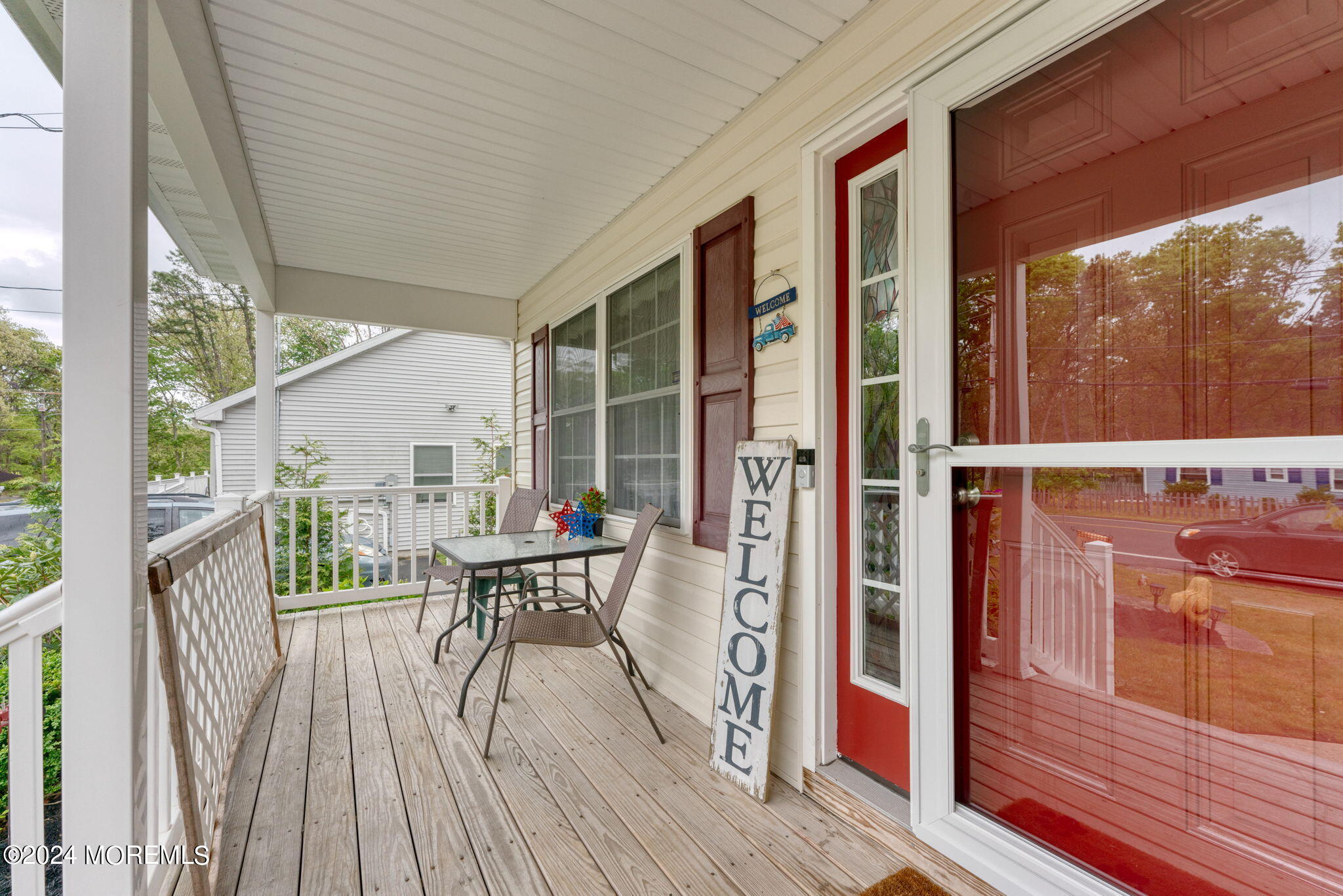 83 Gunning River Road Barnegat, NJ 08005 - Photo 4 of 24 a balcony with wooden floor table and chairs