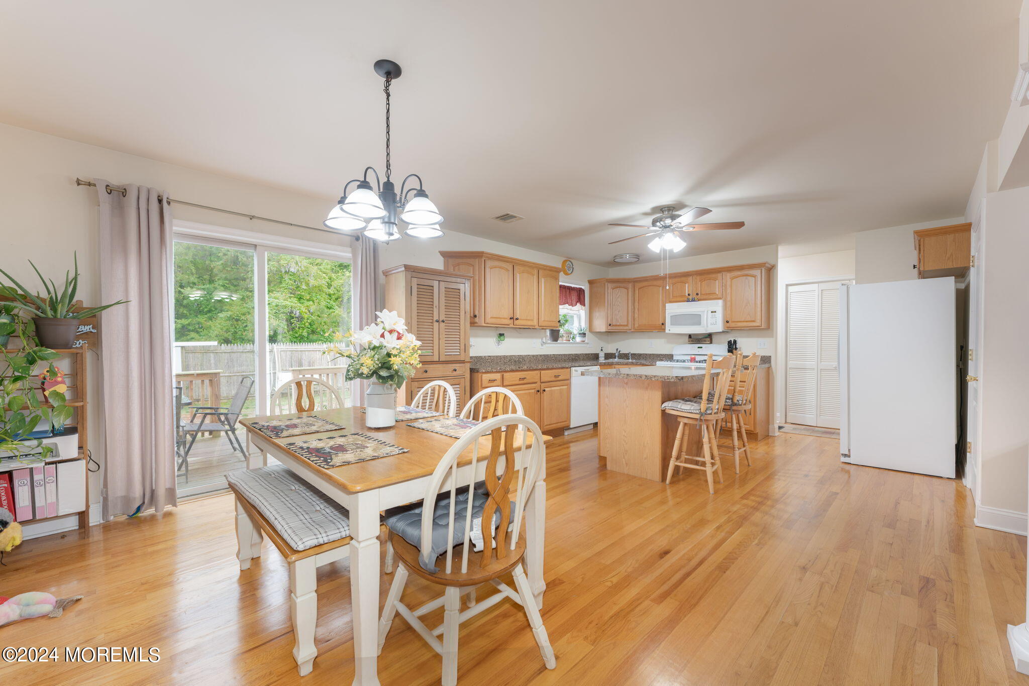 83 Gunning River Road Barnegat, NJ 08005 - Photo 5 of 24 a dining room with furniture a chandelier and wooden floor