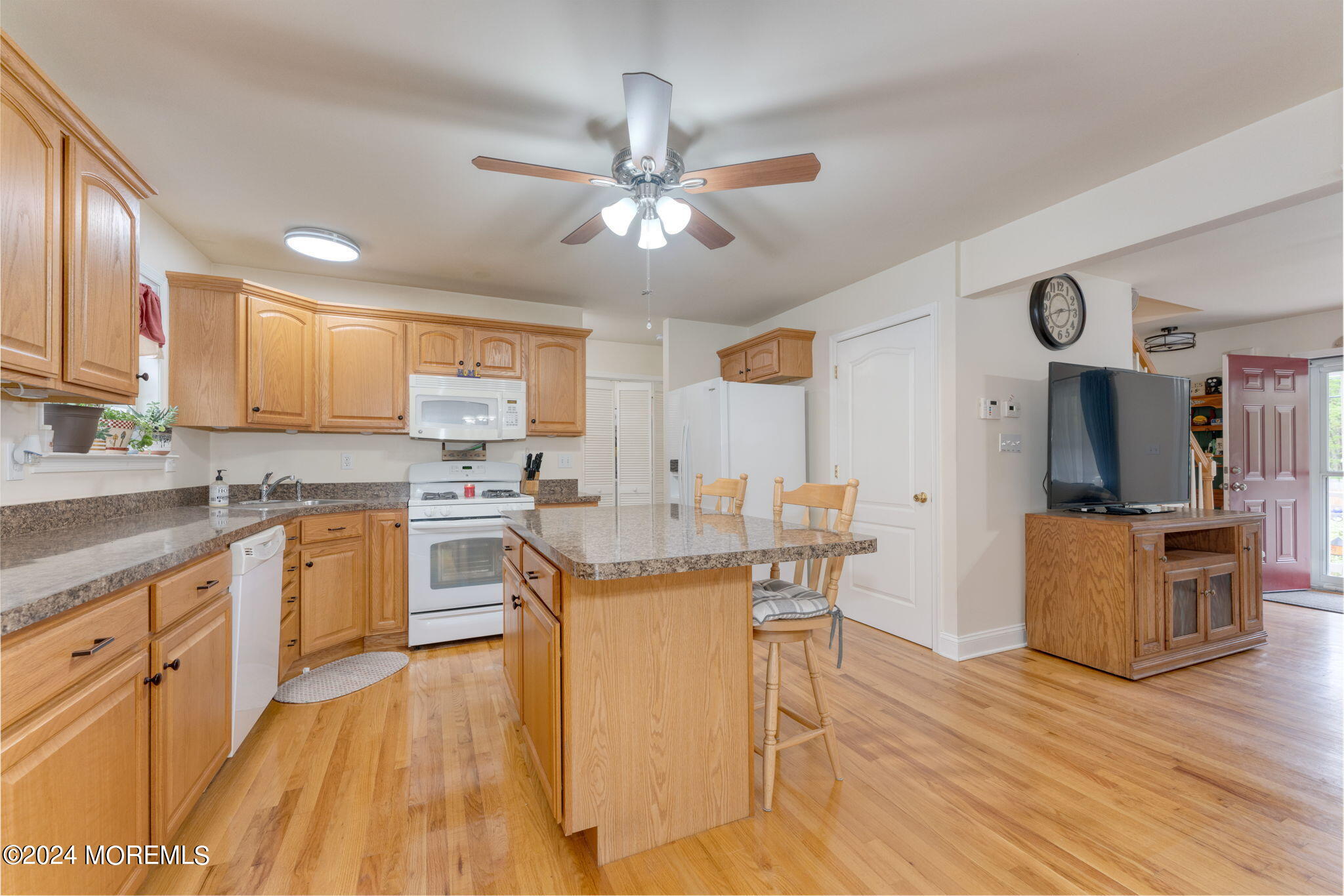 83 Gunning River Road Barnegat, NJ 08005 - Photo 7 of 24 a kitchen with kitchen island granite countertop a sink cabinets and wooden floor