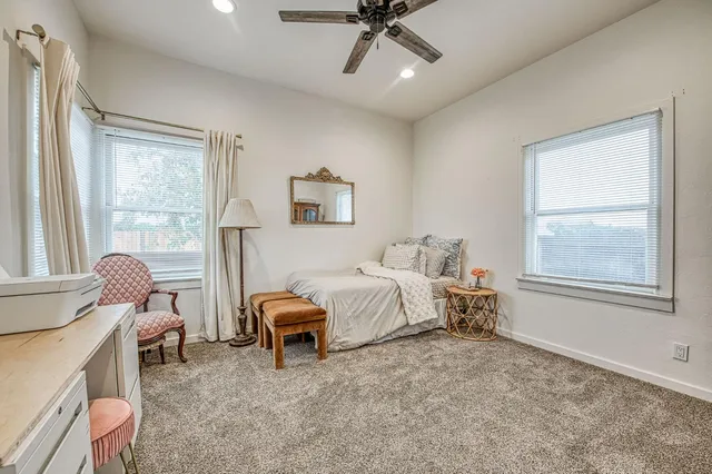 a bed room with a bed and a chair