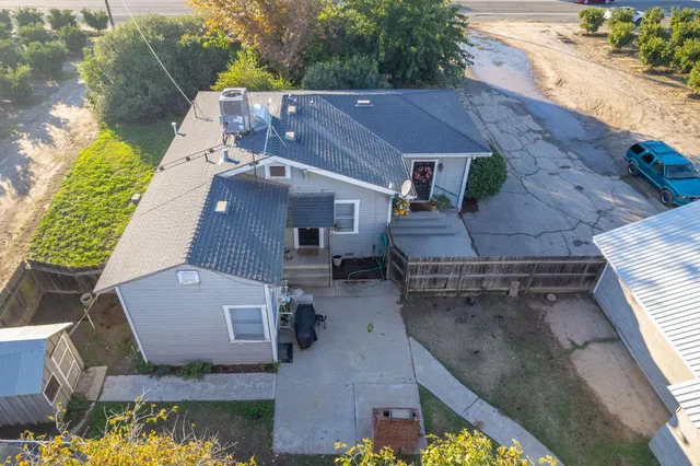 an aerial view of a house with a yard