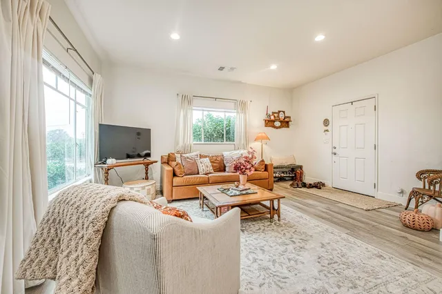 a living room with furniture window and a table
