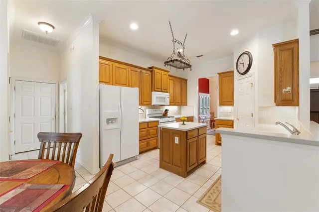 a view of a swimming pool with a table and chairs under an umbrella