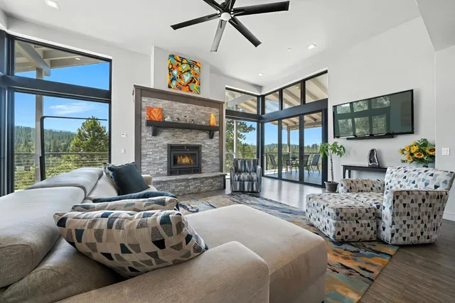 a living room with furniture a fireplace and a flat screen tv