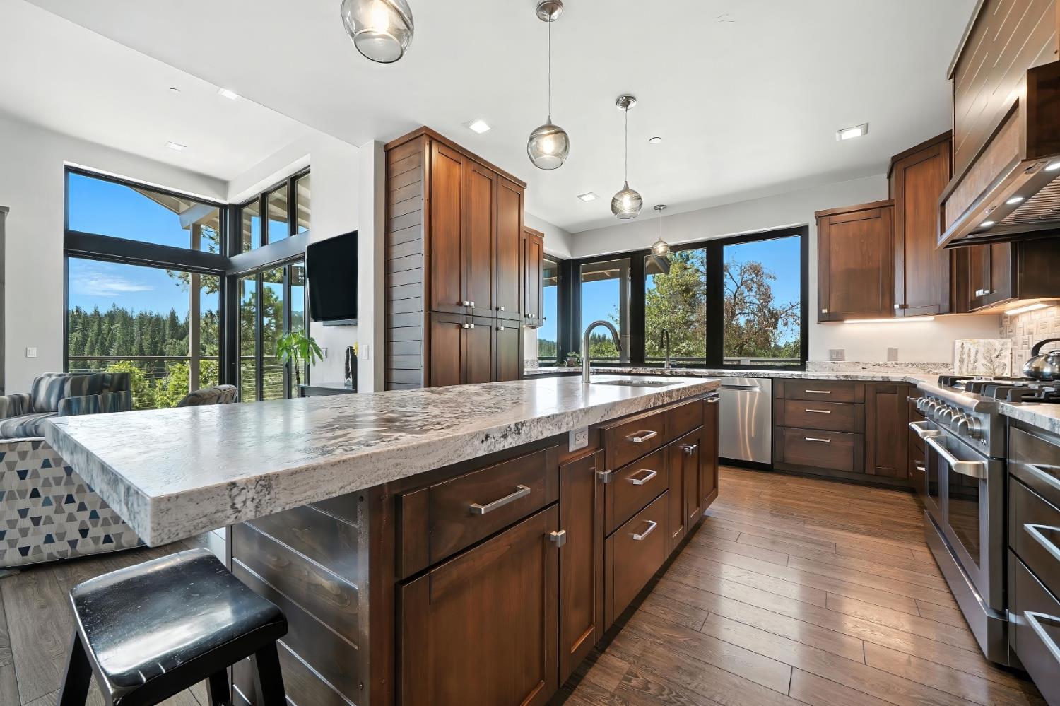 7401 Schaad Road Wilseyville, CA 95257 - Photo 22 of 76 a large kitchen with kitchen island a large island in the center and stainless steel appliances
