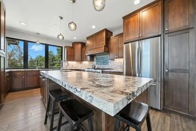 a kitchen with granite countertop stainless steel appliances and wooden cabinets