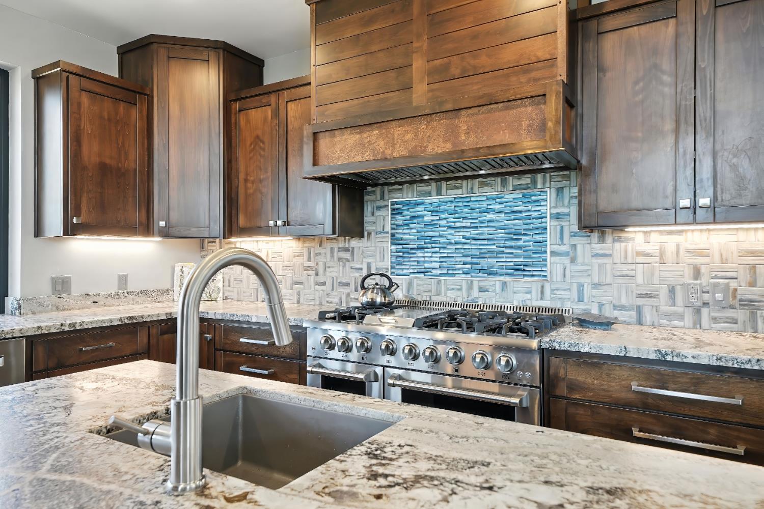 7401 Schaad Road Wilseyville, CA 95257 - Photo 25 of 76 a kitchen with stainless steel appliances granite countertop a stove a sink and a microwave