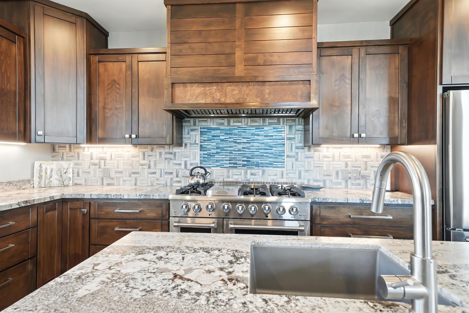7401 Schaad Road Wilseyville, CA 95257 - Photo 26 of 76 a kitchen with granite countertop a sink and a stove top oven