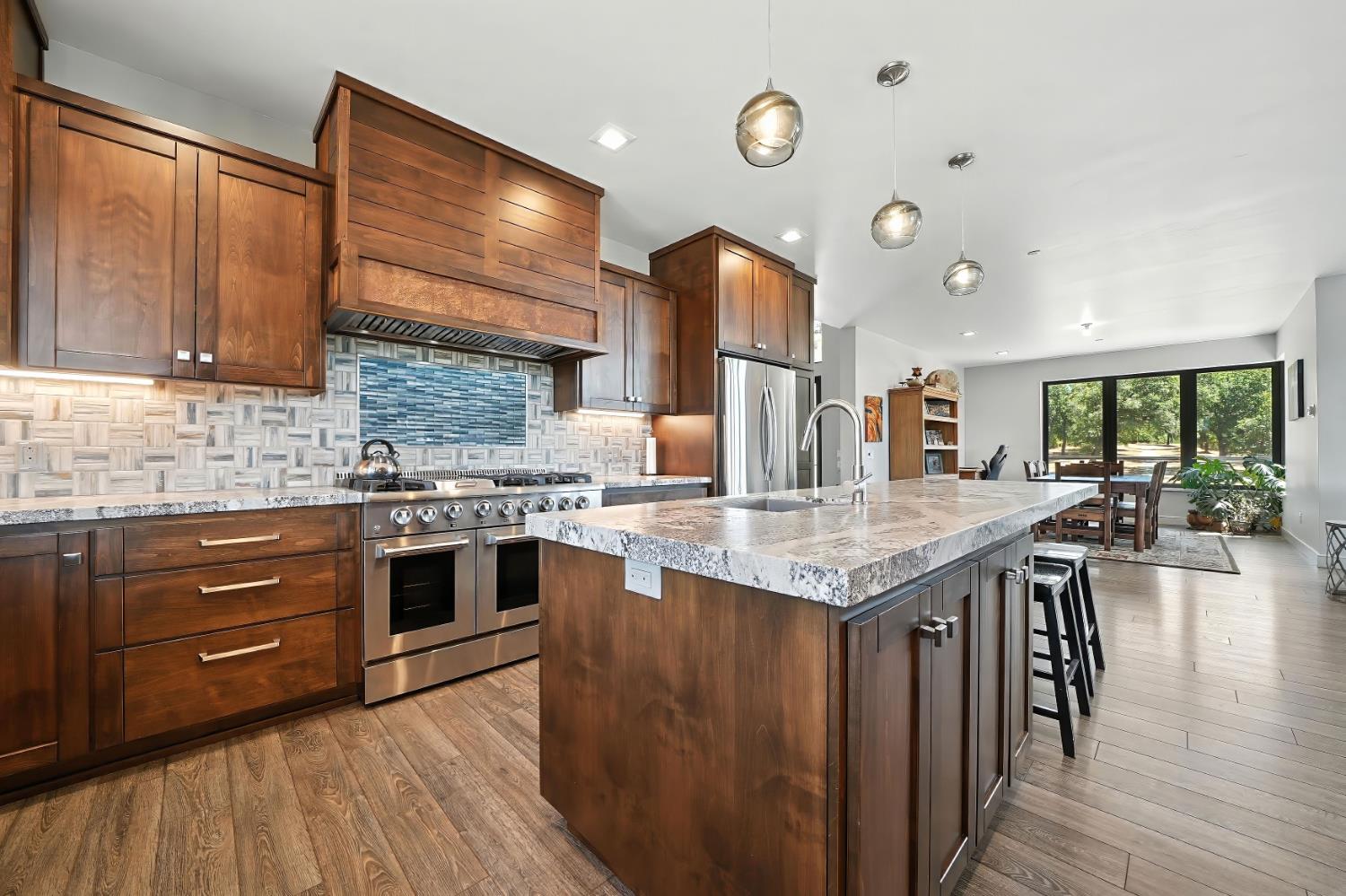 7401 Schaad Road Wilseyville, CA 95257 - Photo 30 of 76 a kitchen with stainless steel appliances granite countertop a stove and cabinets