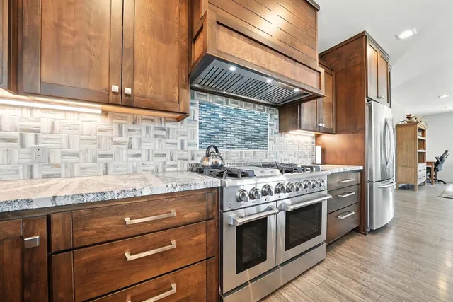 a bathroom with a granite countertop sink a toilet and a bathtub