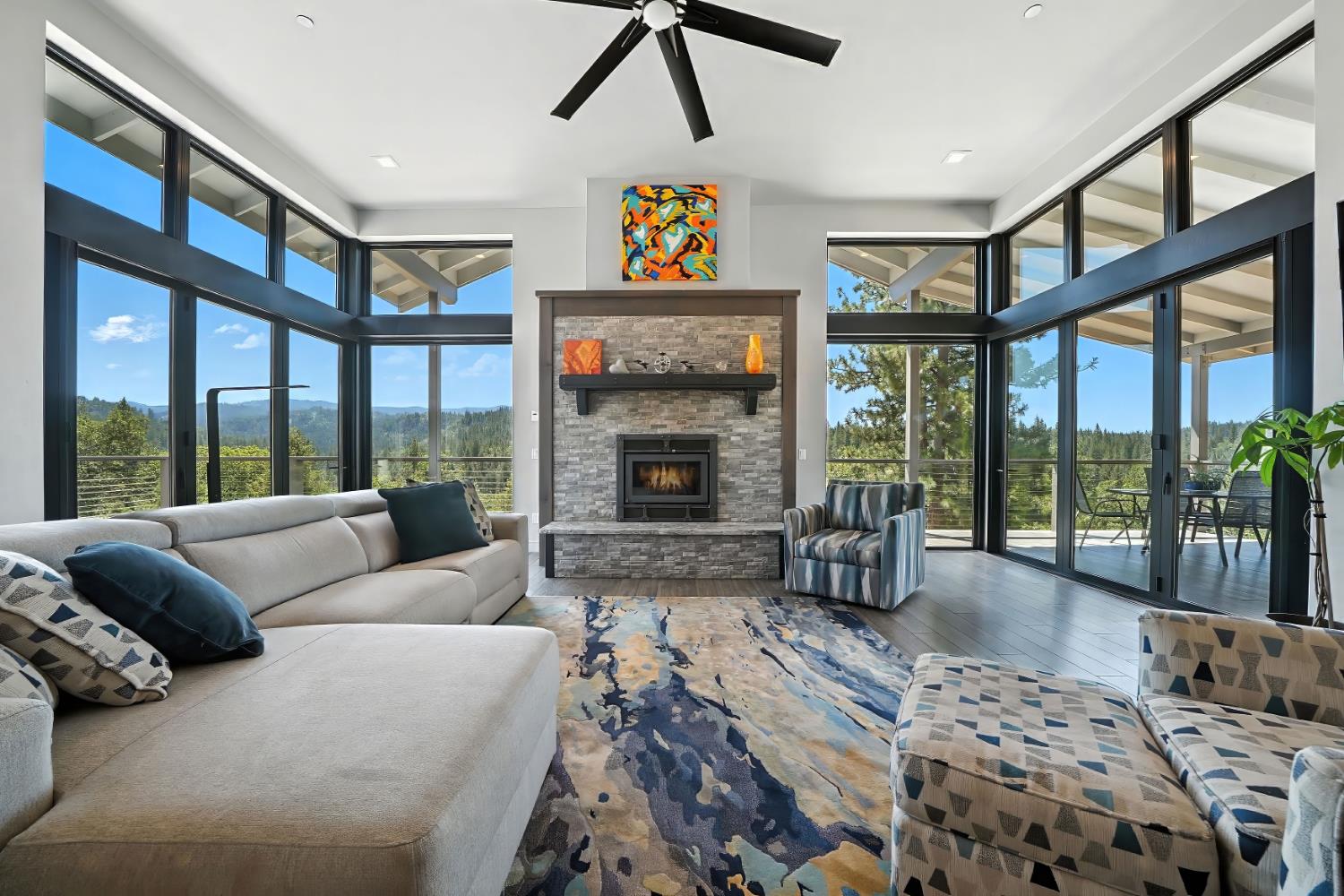 7401 Schaad Road Wilseyville, CA 95257 - Photo 10 of 76 a living room with furniture large windows and a fireplace
