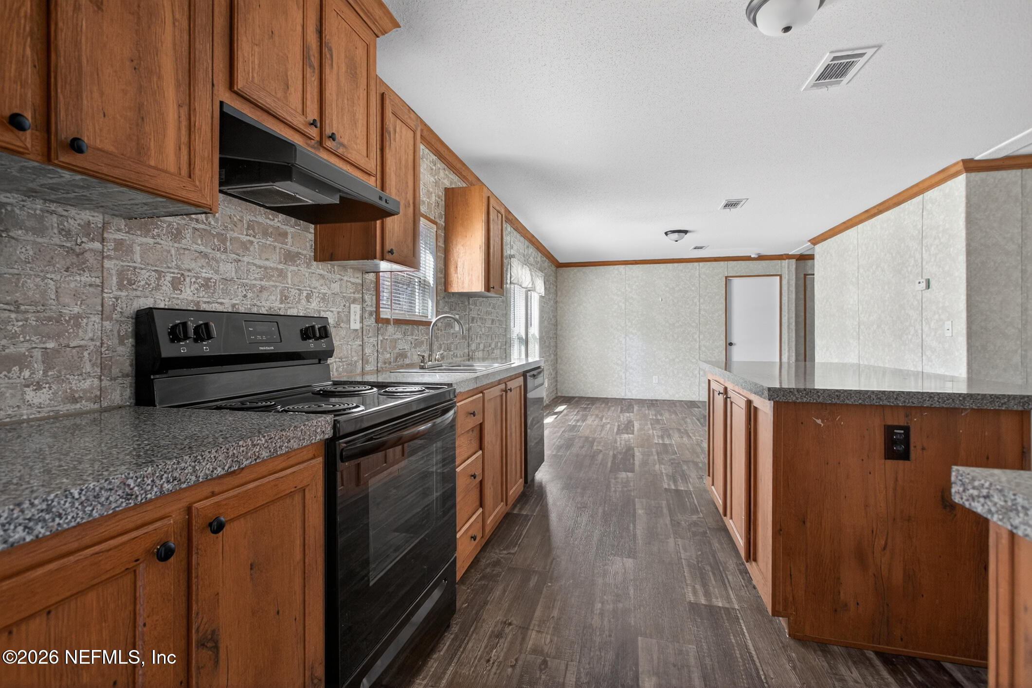 69 Azalea Avenue Middleburg, FL 32068 - Photo 3 of 41 a kitchen with stainless steel appliances granite countertop a stove a sink and a microwave
