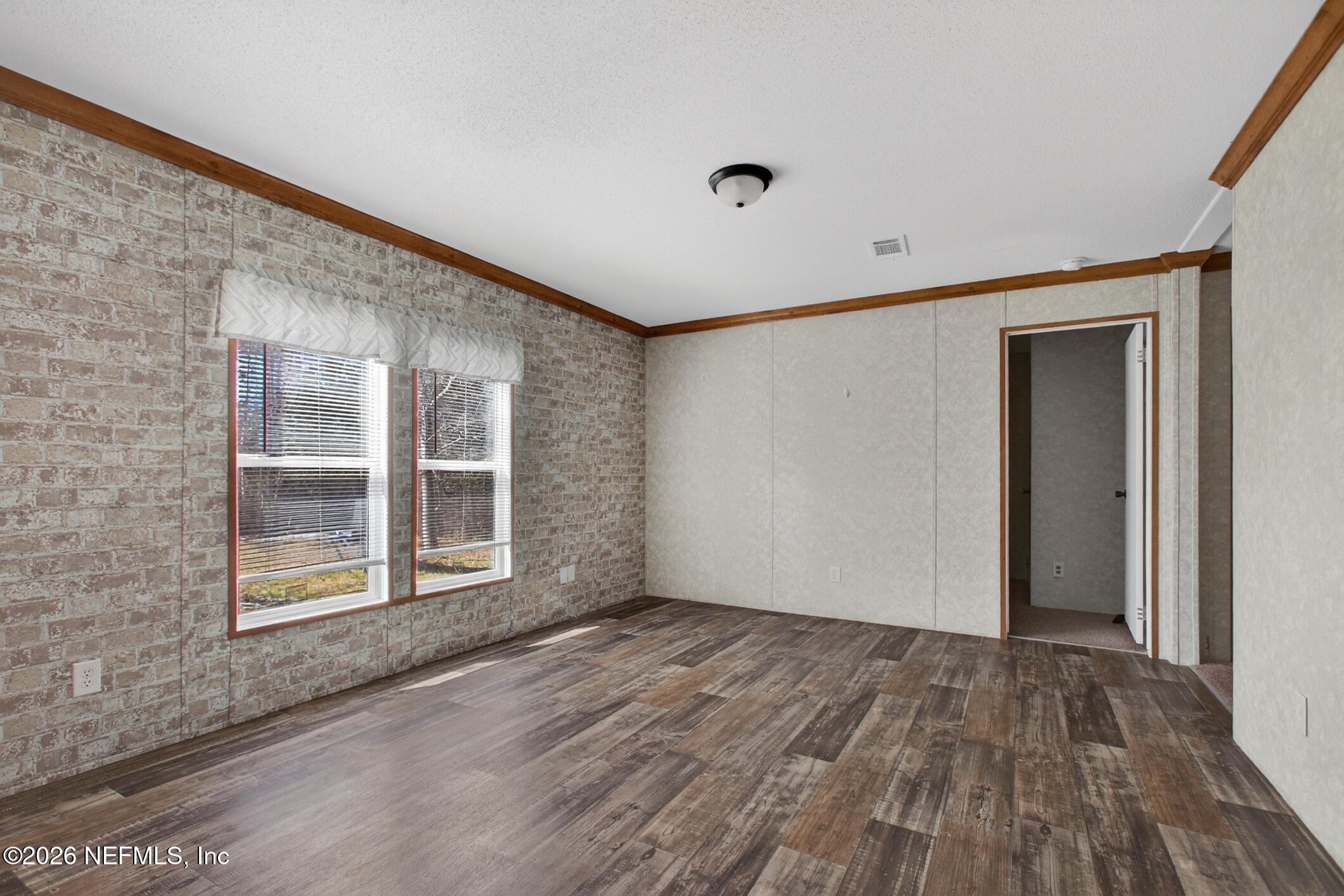 69 Azalea Avenue Middleburg, FL 32068 - Photo 4 of 41 a view of an empty room with wooden floor and a window