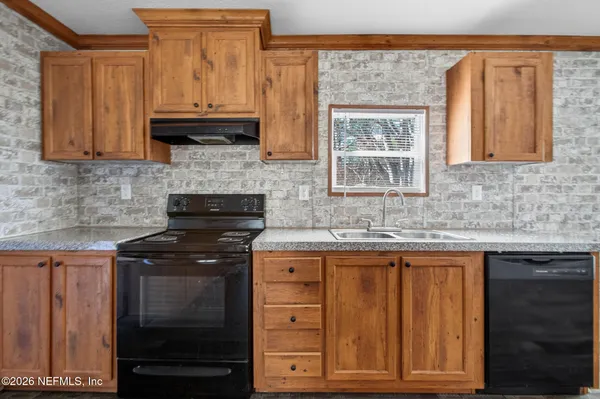 a kitchen with stainless steel appliances granite countertop a refrigerator a sink and a stove