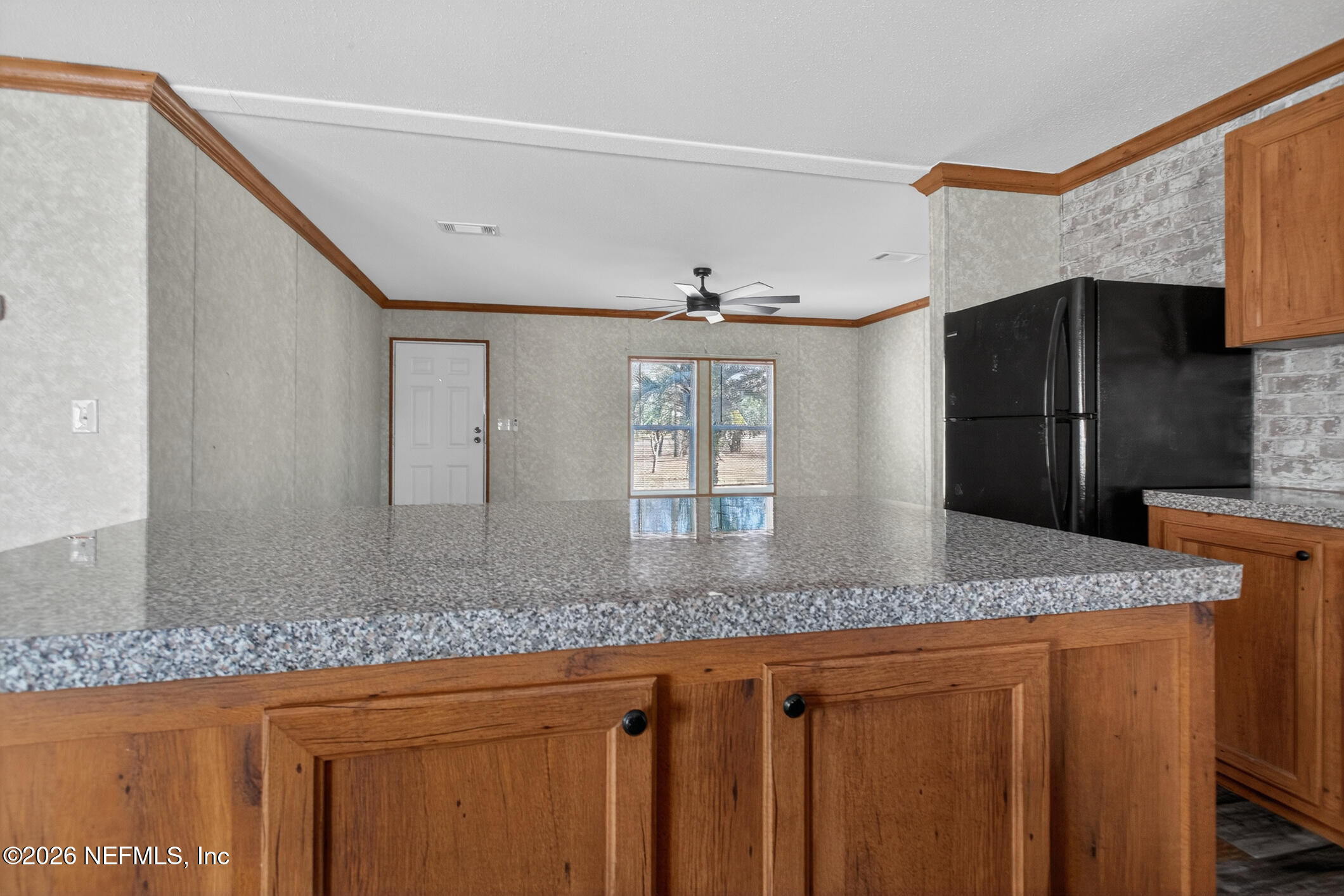 69 Azalea Avenue Middleburg, FL 32068 - Photo 9 of 41 a kitchen with stainless steel appliances granite countertop a sink and a refrigerator
