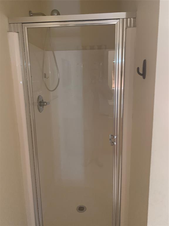 3190 Southwest Curcuma Street Port St. Lucie, FL 34953 - Photo 14 of 19 a bathroom with a glass shower door
