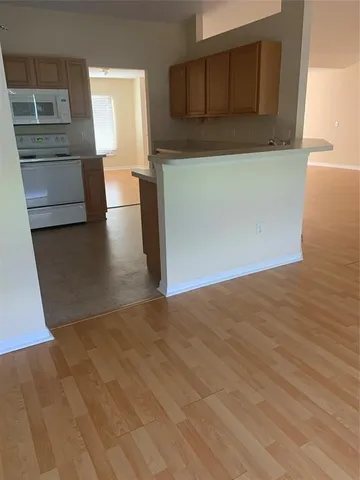 a view of a kitchen with furniture and an empty room