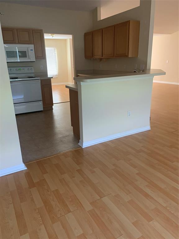 3190 Southwest Curcuma Street Port St. Lucie, FL 34953 - Photo 4 of 19 a view of a kitchen with furniture and an empty room