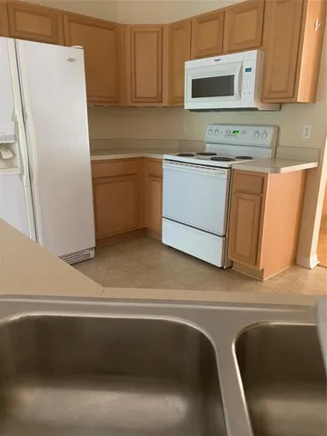 a kitchen with a refrigerator sink and microwave
