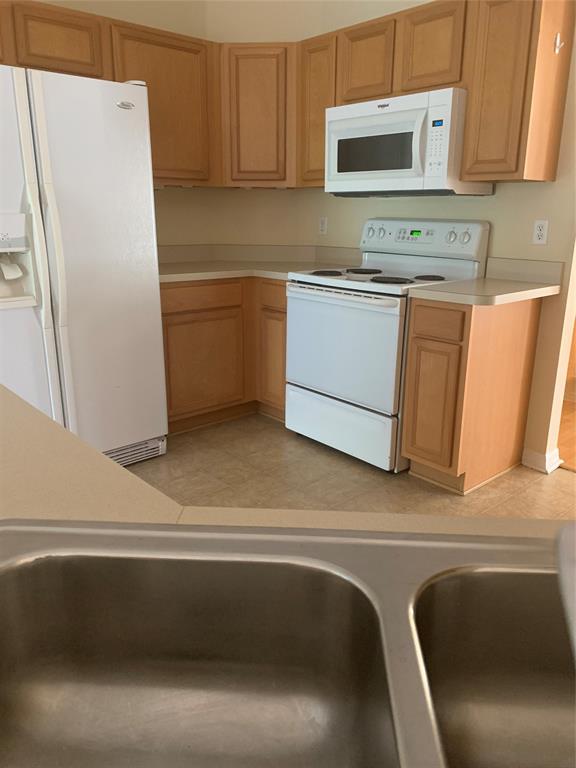 3190 Southwest Curcuma Street Port St. Lucie, FL 34953 - Photo 5 of 19 a kitchen with a refrigerator sink and microwave