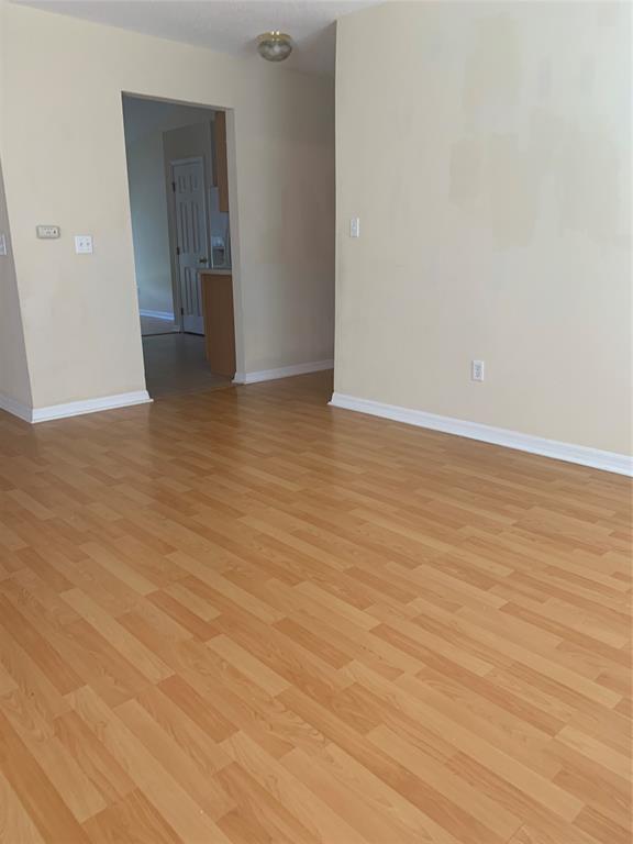 3190 Southwest Curcuma Street Port St. Lucie, FL 34953 - Photo 9 of 19 a view of a room with wooden floor