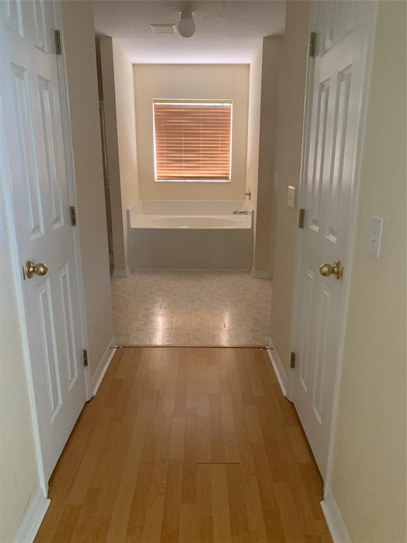 3190 Southwest Curcuma Street Port St. Lucie, FL 34953 - Photo 10 of 19 a view of an empty room with wooden floor and a window
