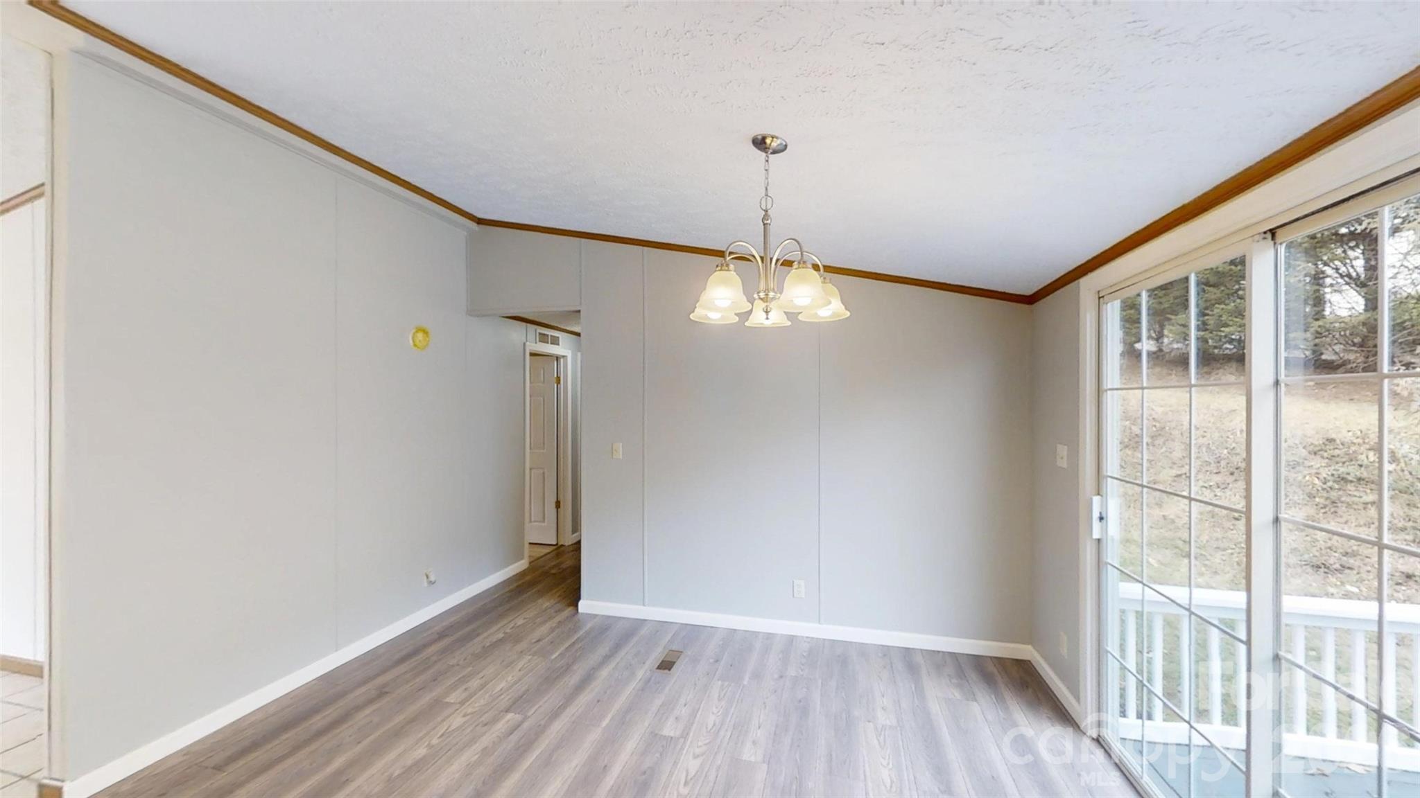 71 London Lane Clyde, NC 28721 - Photo 16 of 33 a view of empty room with wooden floor and fan