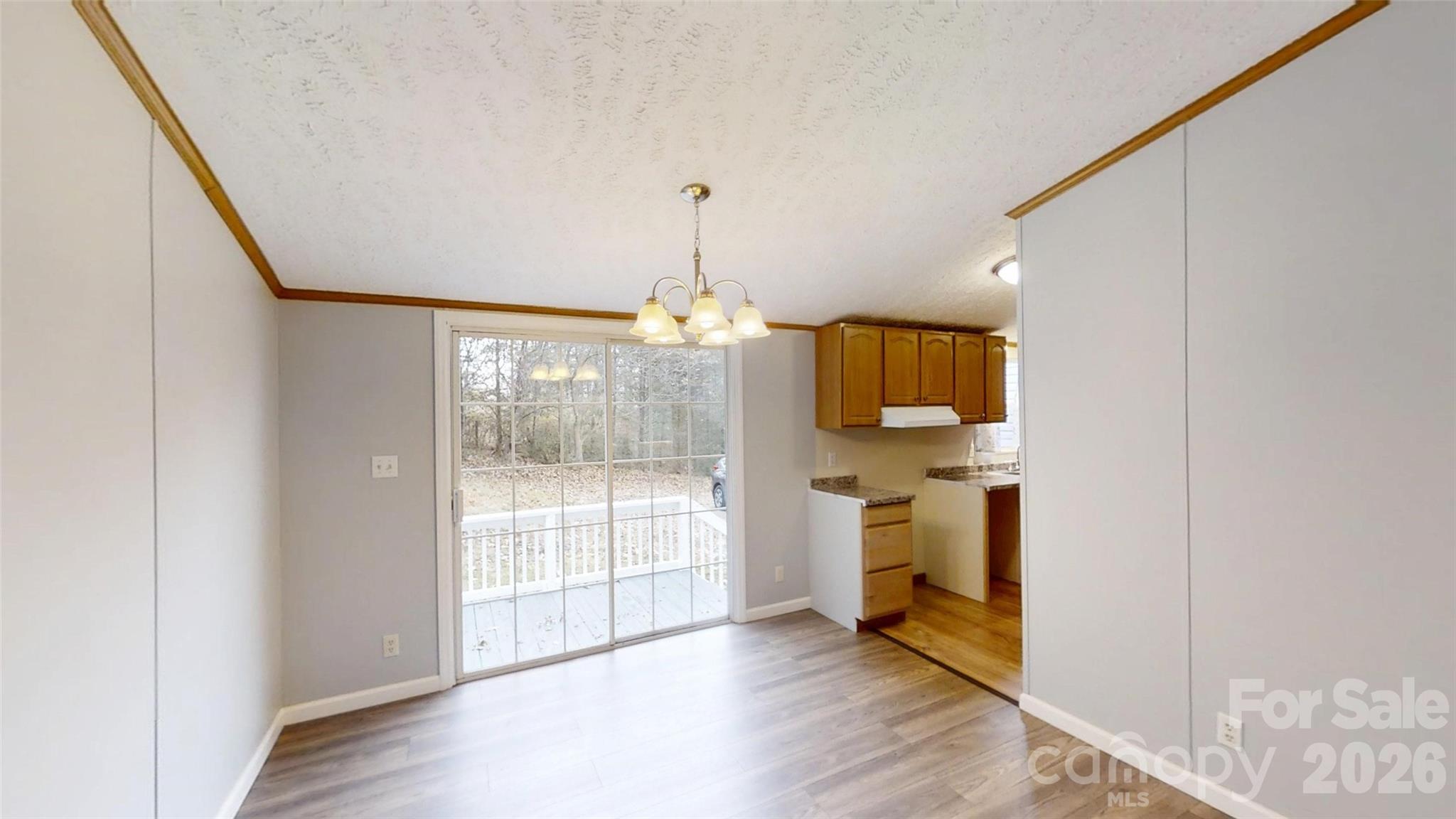 71 London Lane Clyde, NC 28721 - Photo 17 of 33 a view of empty room with wooden floor and windows