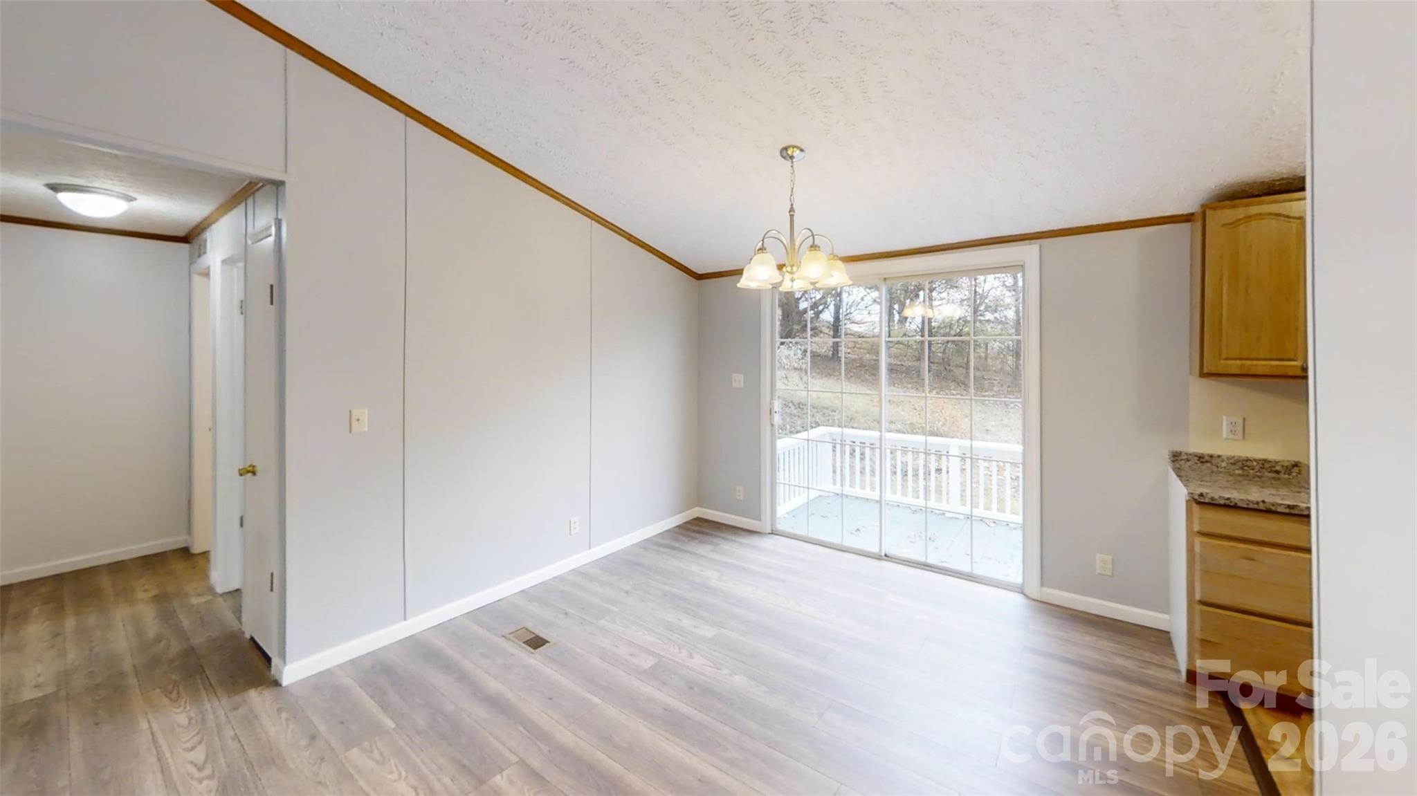71 London Lane Clyde, NC 28721 - Photo 18 of 33 a view of an empty room with wooden floor and a window