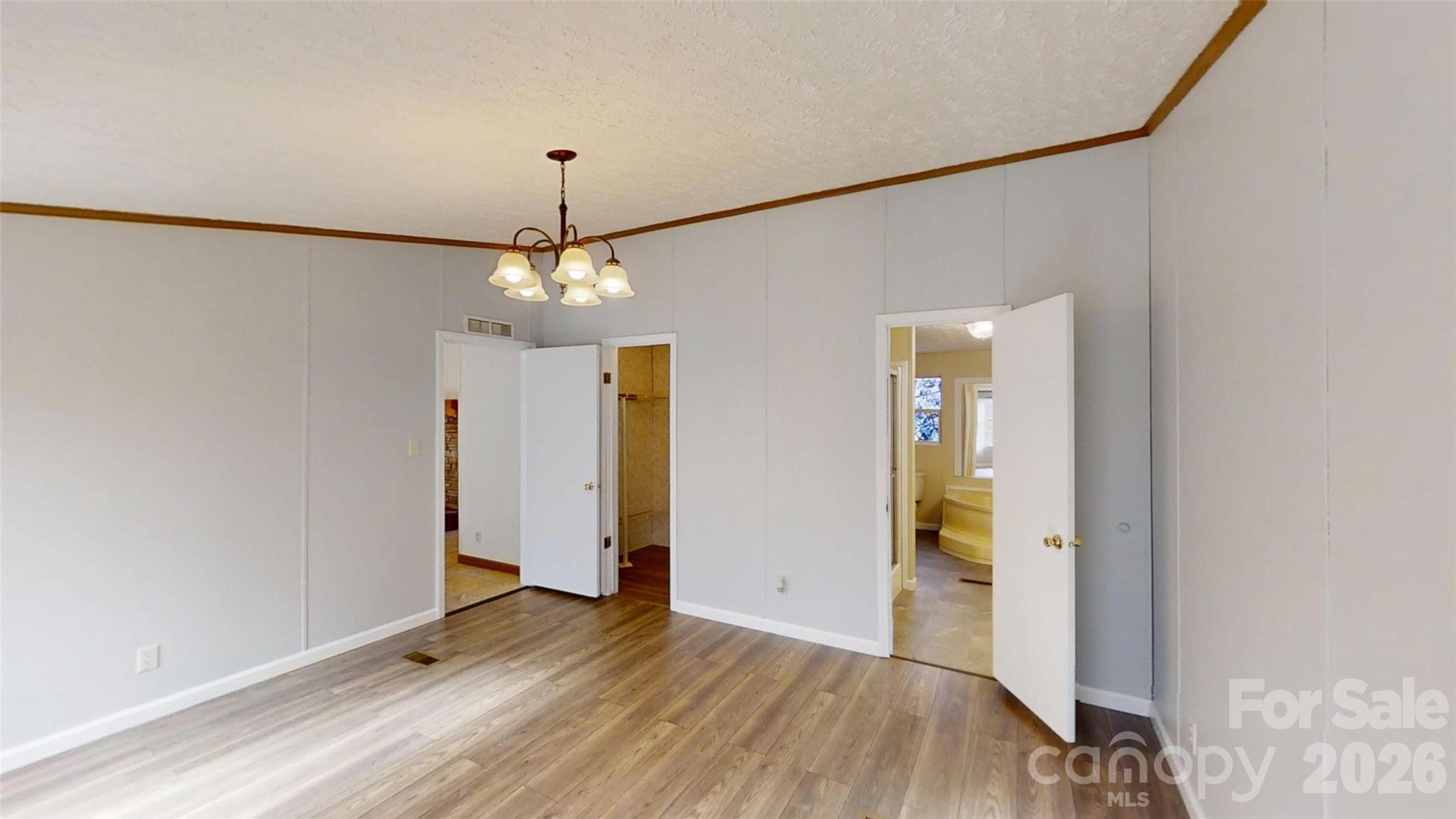 71 London Lane Clyde, NC 28721 - Photo 19 of 33 a view of a room with wooden floor staircase and a hallway