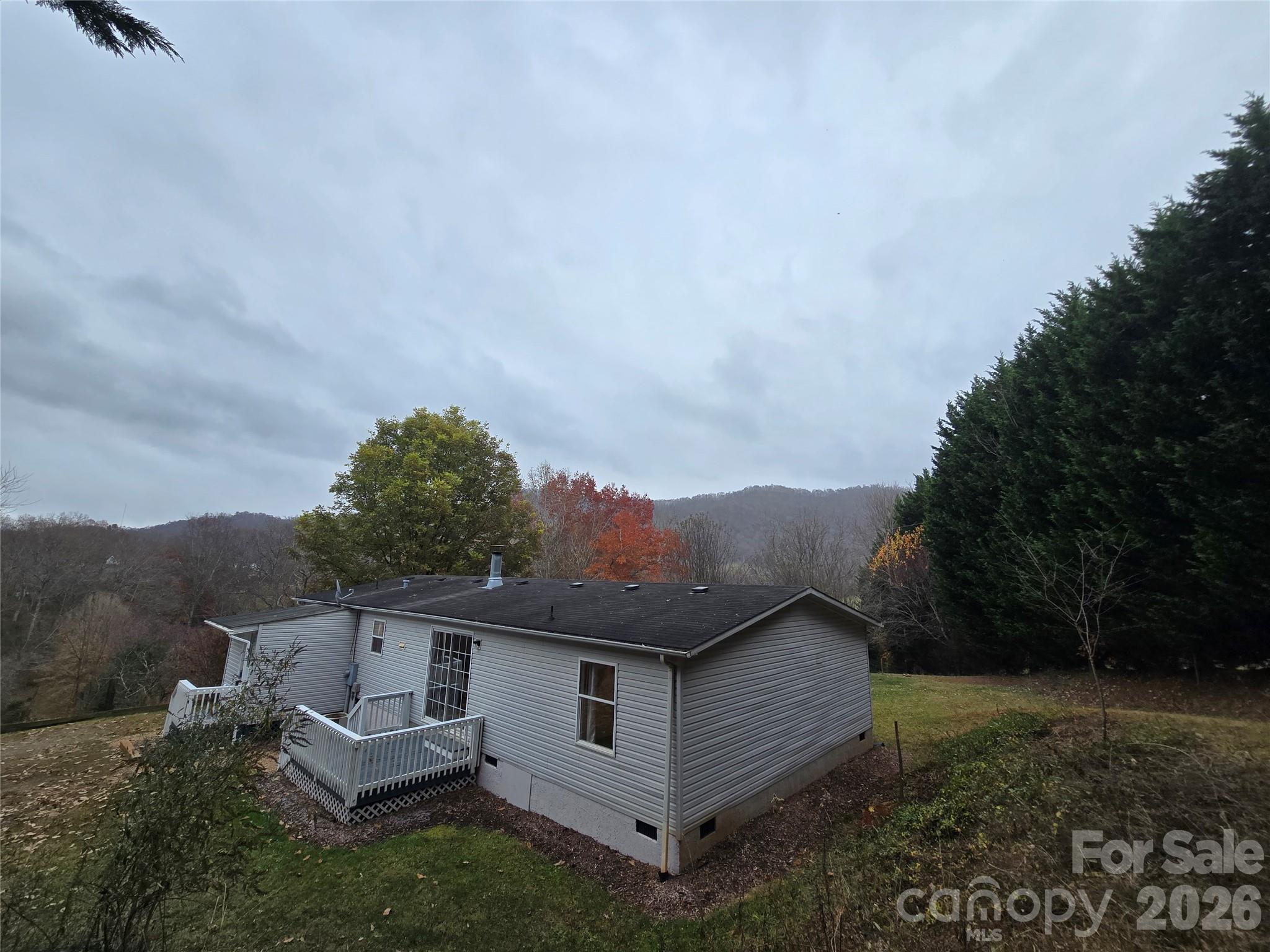71 London Lane Clyde, NC 28721 - Photo 2 of 33 a view of a house with a yard and roof