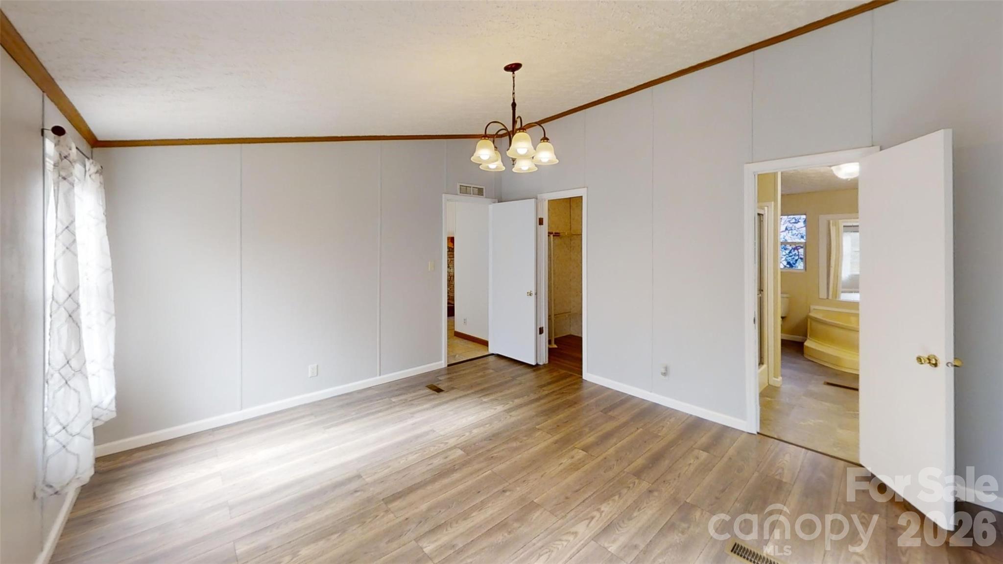 71 London Lane Clyde, NC 28721 - Photo 21 of 33 a view of a room with wooden floor closet and windows