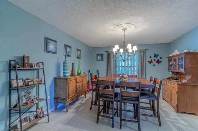 a bedroom with a bed a window and painting on the wall