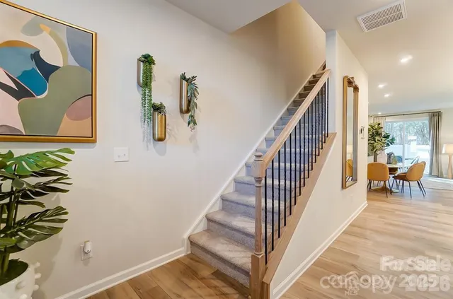 a view of entryway and hall with wooden floor