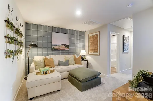 a living room with furniture and a potted plant