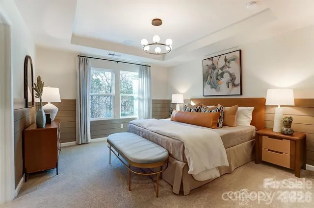 a bedroom with a bed and a chandelier