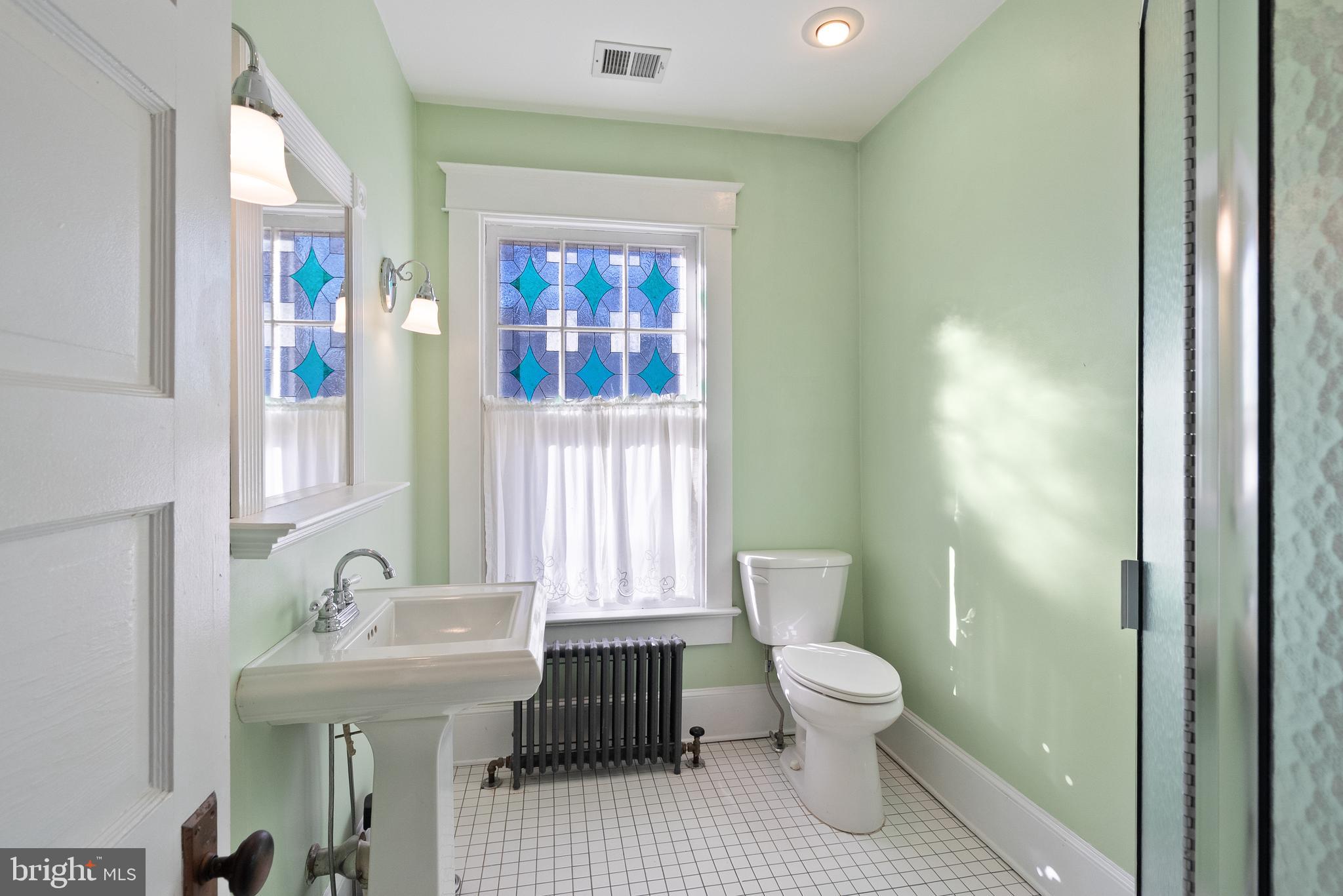 820 Locust Street Herndon, VA 20170 - Photo 26 of 55 a bathroom with a toilet a sink and a mirror