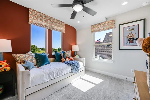 a view of a living room with furniture and floor to ceiling window
