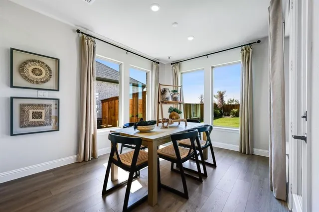a living room with furniture kitchen view and a wooden floor