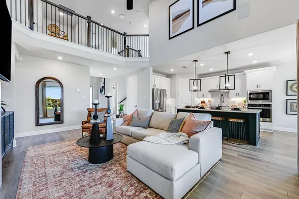 a living room with furniture a flat screen tv and a fireplace
