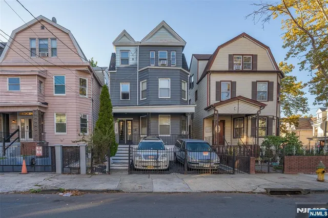 a front view of a residential apartment building with a yard