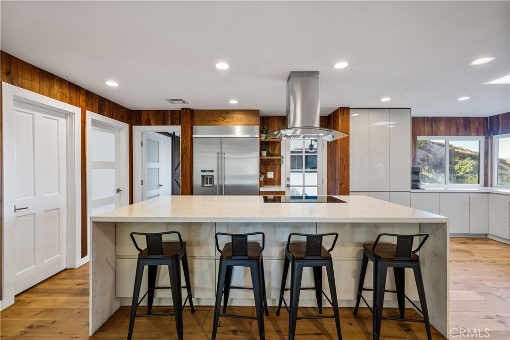 16337 Ravenglen Road Canyon Country, CA 91387 - Photo 16 of 50 a kitchen with counter space and chairs in it