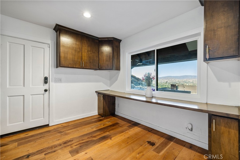 16337 Ravenglen Road Canyon Country, CA 91387 - Photo 19 of 50 a view of a kitchen with wooden floor and a window