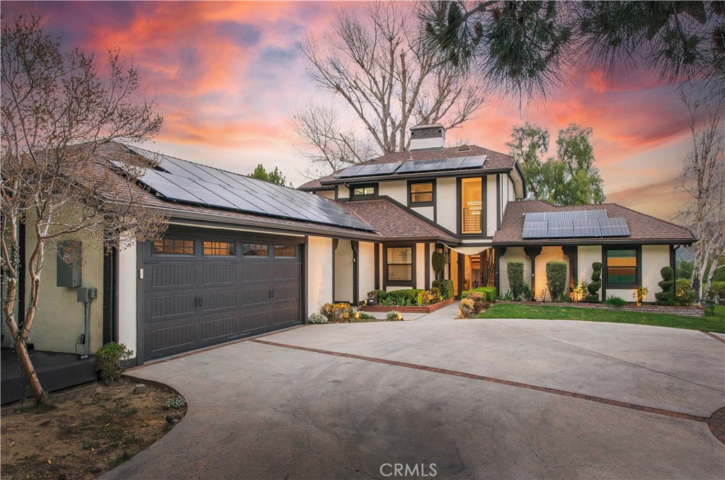 16337 Ravenglen Road Canyon Country, CA 91387 - Photo 2 of 50 a front view of a house with a yard and garage