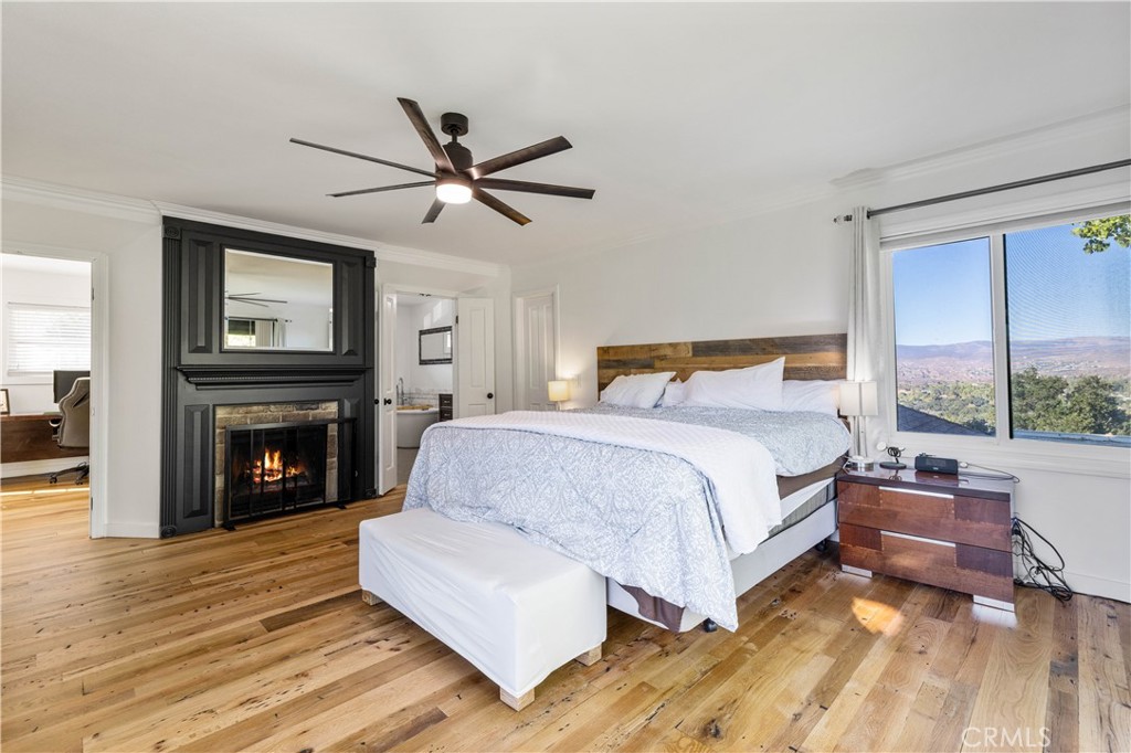 16337 Ravenglen Road Canyon Country, CA 91387 - Photo 26 of 50 a bedroom with a large bed and a fireplace