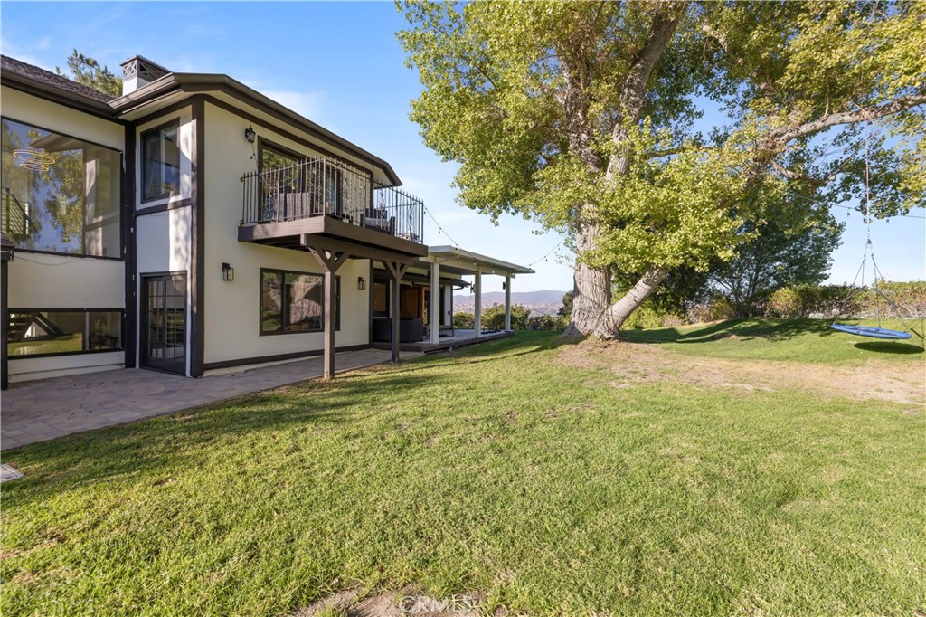 16337 Ravenglen Road Canyon Country, CA 91387 - Photo 34 of 50 a front view of a house with a yard table and chairs